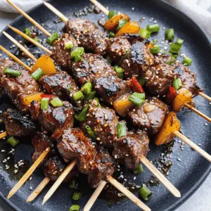Get ready for a flavor-packed dinner with these Asian Garlic Steak Skewers! Tender beef marinated in a savory blend of garlic and soy sauce makes for a deliciously easy recipe. Perfect for your next barbecue or weeknight meal! Save this pin to try it out later and impress your friends and family with these mouthwatering skewers!