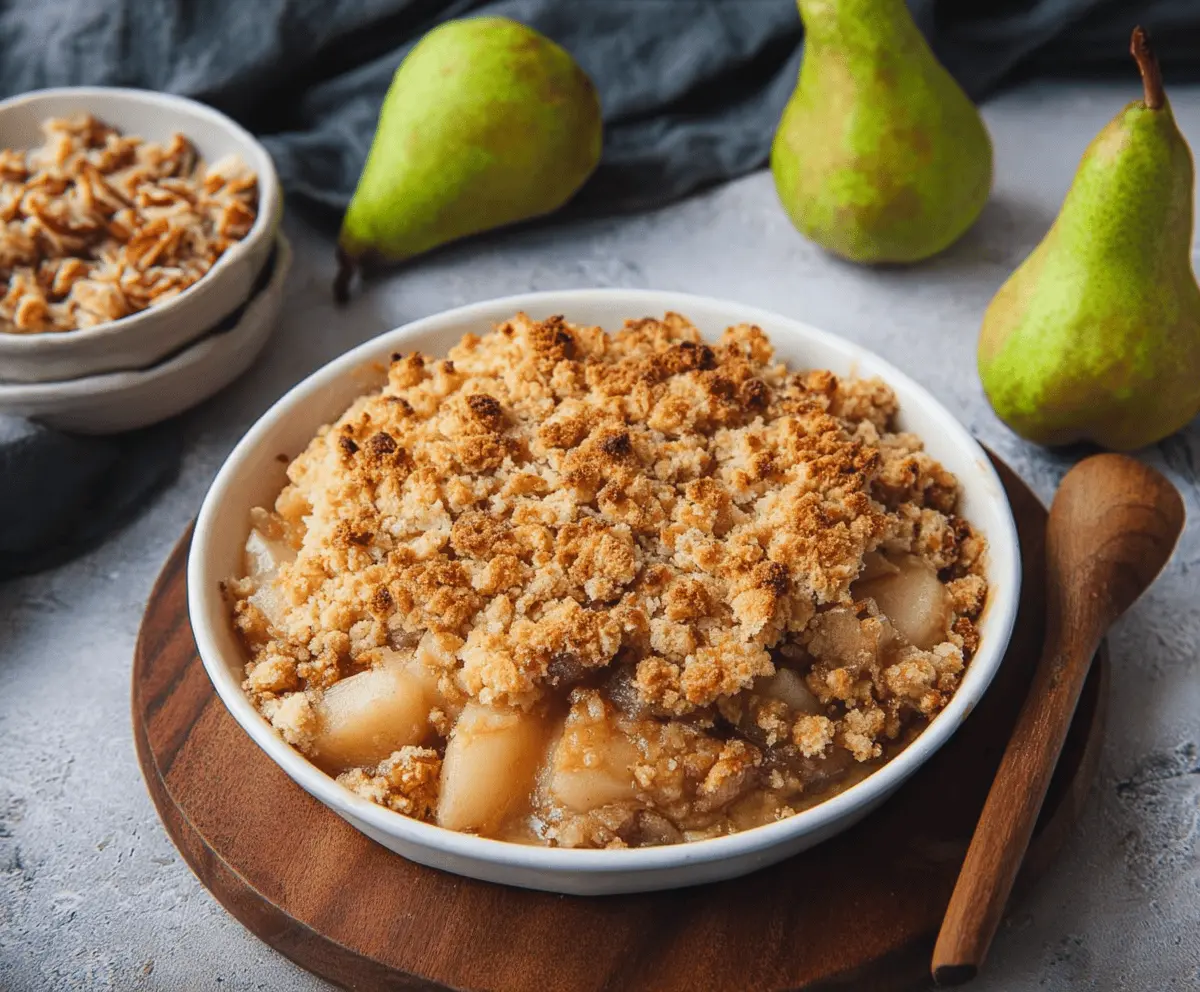 Delicious homemade pear crumble with golden-brown topping served in a rustic dish, perfect for a cozy dessert