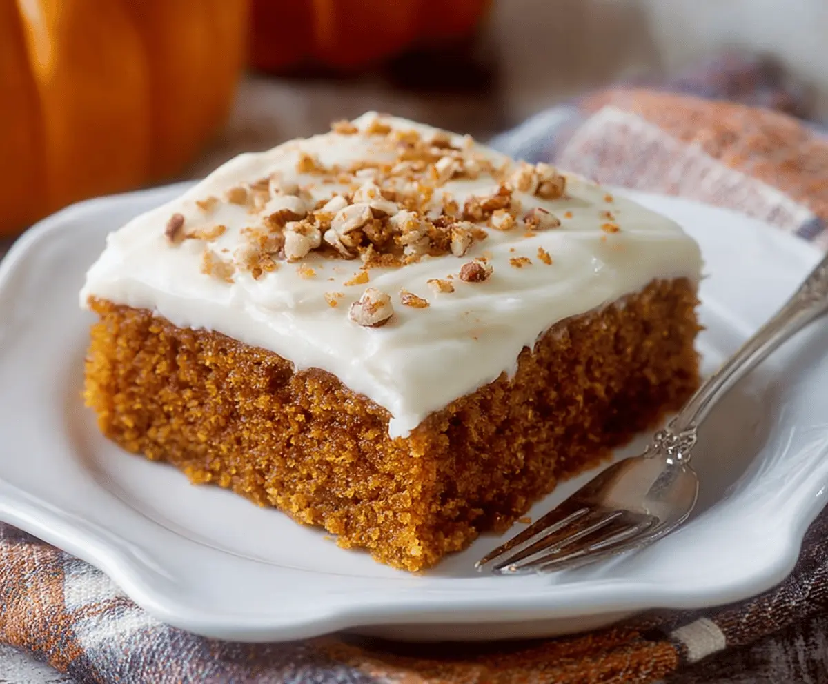 Delicious pumpkin sheet cake topped with creamy cream cheese frosting, perfect for fall desserts and gatherings.