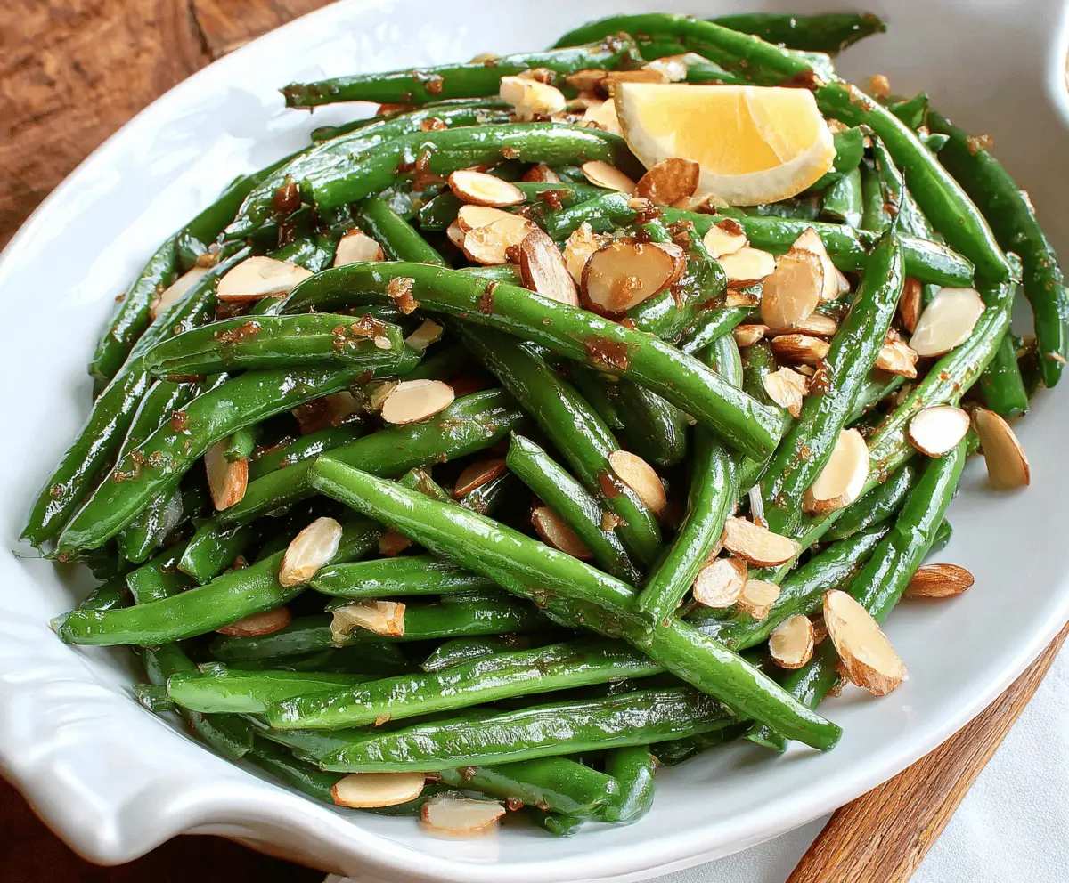 A plate of fresh green beans Almondine garnished with toasted almonds for a delicious side dish.