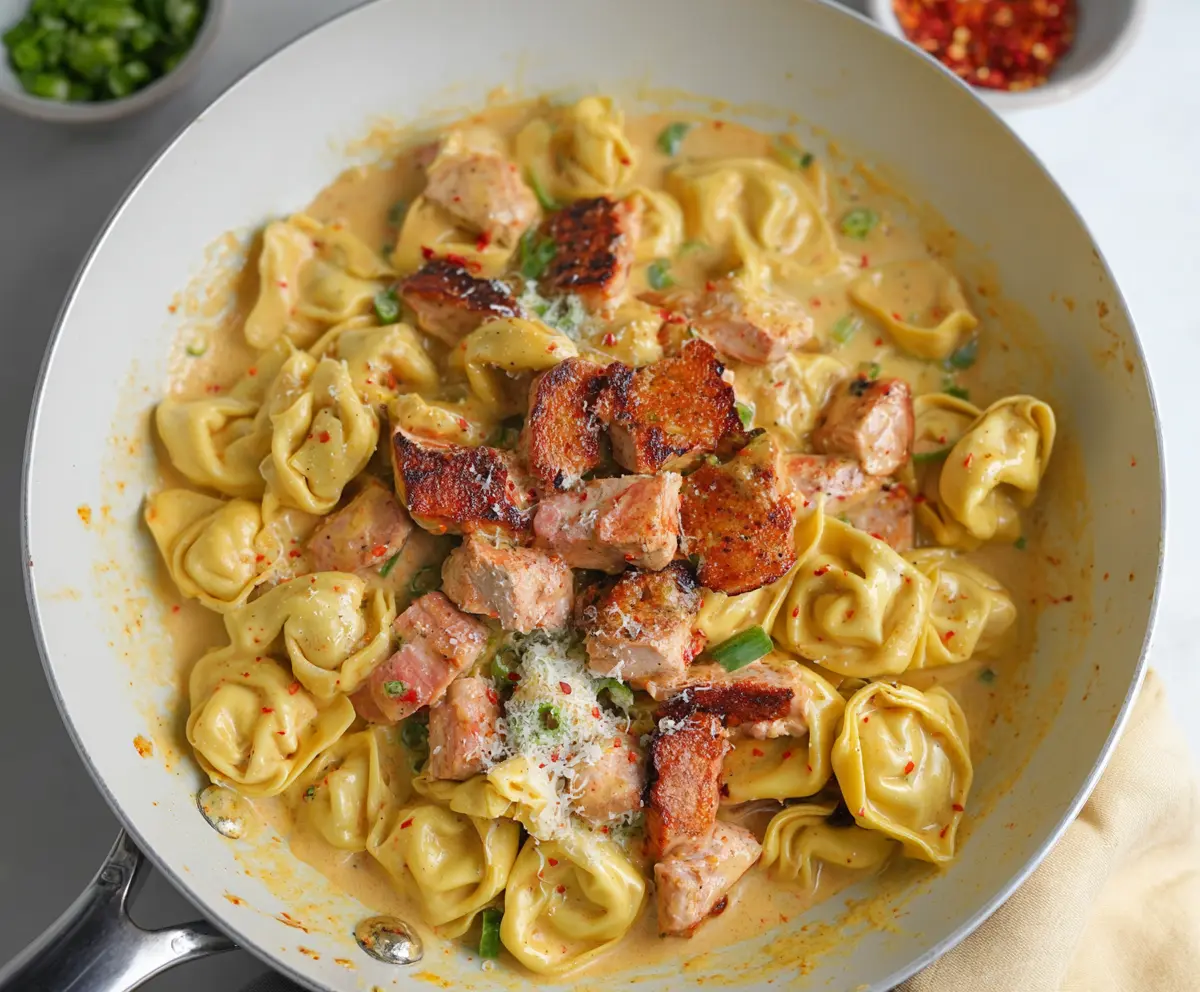 Savory Cajun Chicken Tortellini with spices and creamy sauce in a bowl