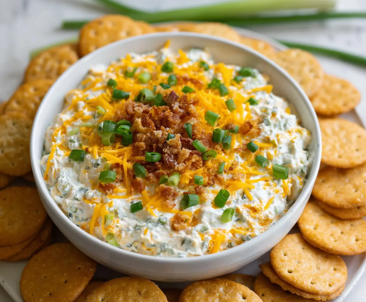 Creamy Cheddar Ranch Crack Dip served with fresh vegetables and chips.
