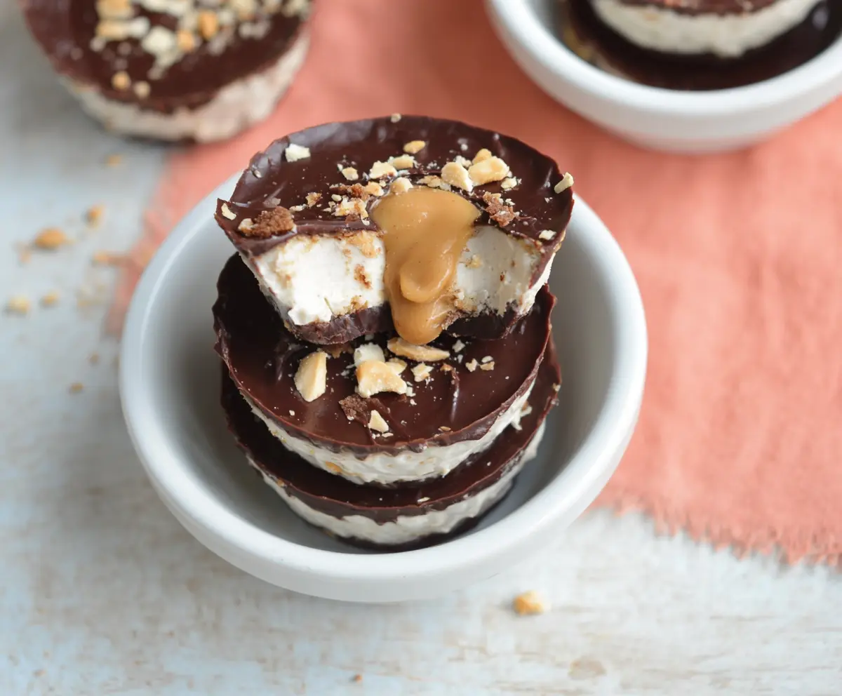 Delicious Greek Yogurt Peanut Butter Protein Cups on a white plate, showcasing a creamy texture and healthy ingredients.