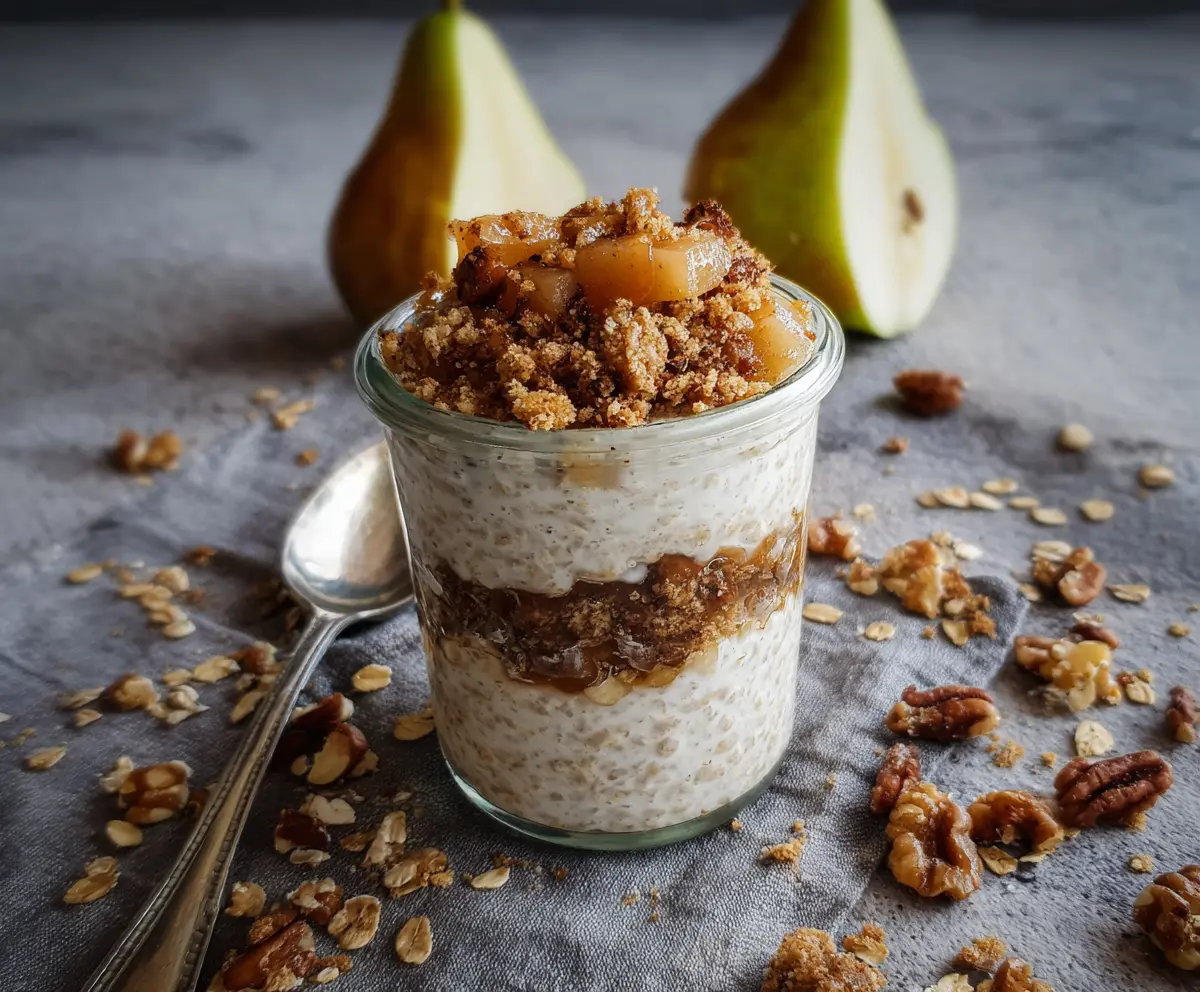 Creamy Pear Crumble Overnight Oats topped with fresh fruit and crunchy crumble for a healthy breakfast.