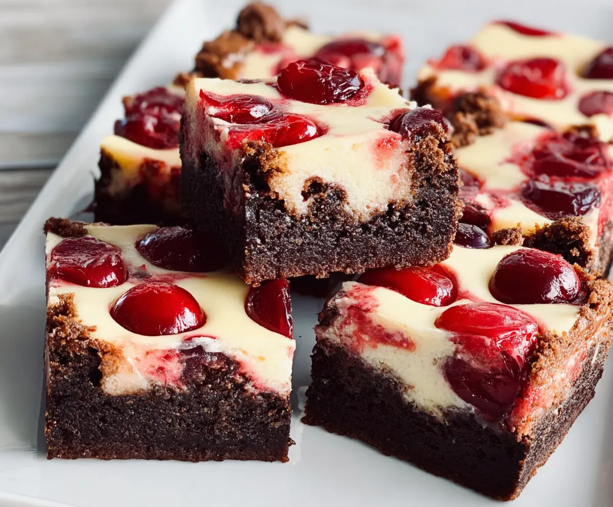 Delicious Cherry Cheesecake Brownies with cherry topping and creamy cheesecake swirls