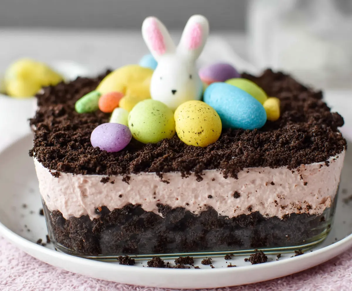 Delicious Easter Dirt Cake with chocolate soil, colorful candy eggs, and festive decorations for a spring celebration.
